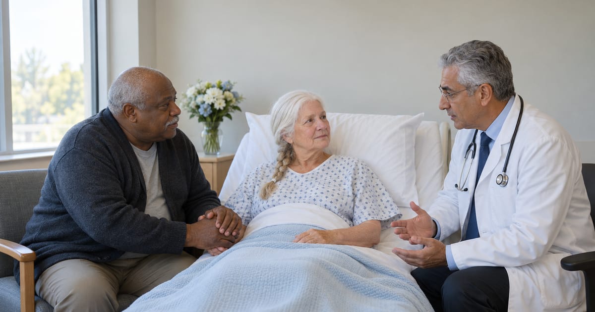 A doctor in a white coat and stethoscope talks with a white-haired woman in a hospital bed as a man beside her holds her hand in both of his